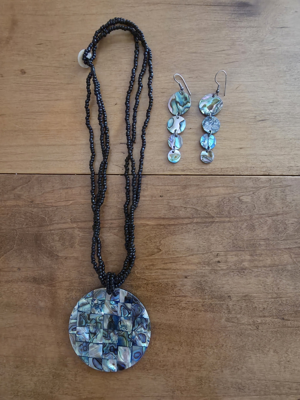 Abalone pendant on black beaded necklace and matching hanging earrings